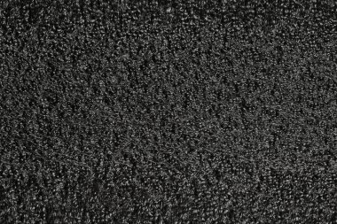 Siyah köpük plastik arka plan dokusu. Tasarımcılar için siyah arkaplan. koyu renk köpük.