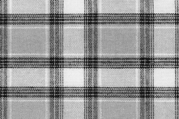 Black and white tartan texture background. shirt fabric with a checkered pattern. factory material