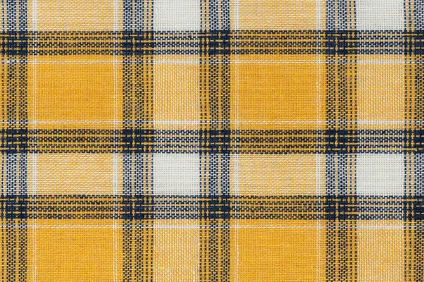 Yellow white tartan texture background. shirt fabric with a checkered pattern. factory material