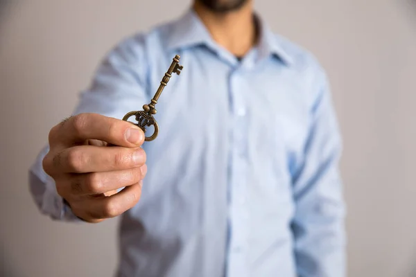 Mann Hält Vintage Schlüssel Auf Grauem Hintergrund — Stockfoto