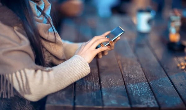Kadın Ahşap Arka Taraftaki Akıllı Telefonu Kullanıyor — Stok fotoğraf
