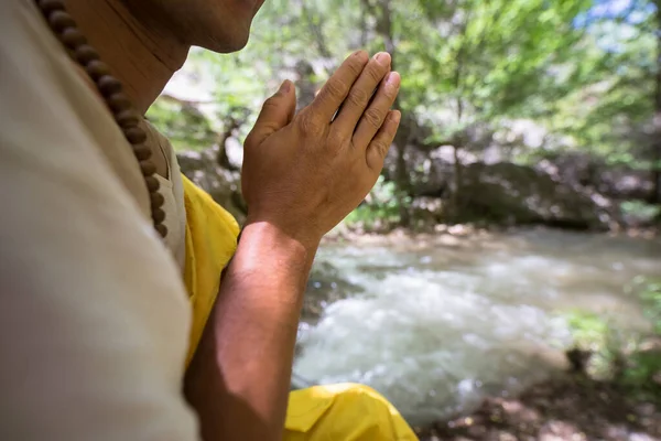 prayer or meditation man in river backgroun