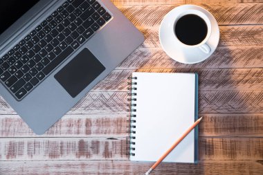 Not defteri ve bir fincan kahveyi masaya koy.