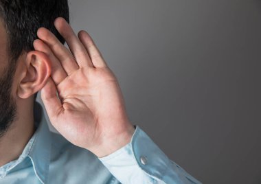 Grey Backgroun 'da adam el ele veriyor.