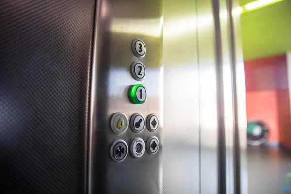 Metallic elevator panel with butto