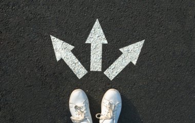 Asfalt üzerinde okların yanında duran kadın.