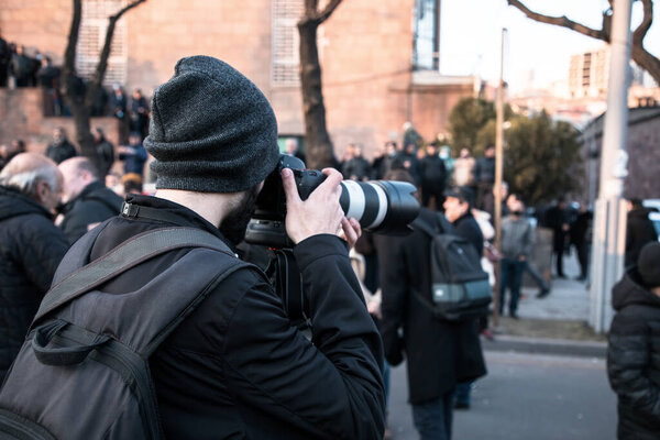 man photographer hand camera in the demonstratio