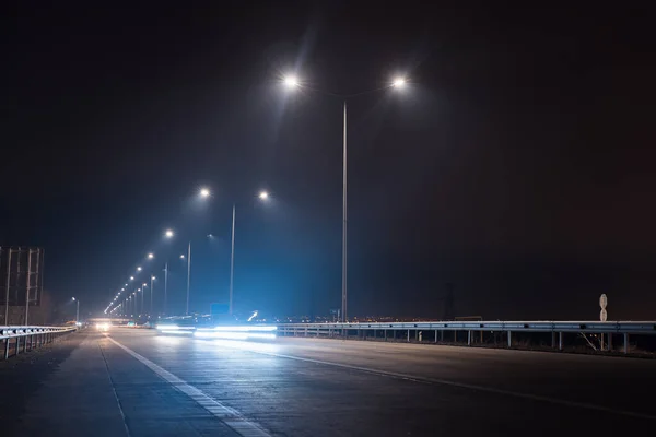 traffic on night road with street lamp