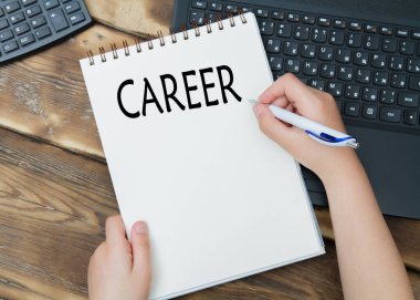 Hands with pen writing career plan on notebook at home or office. (calculator)