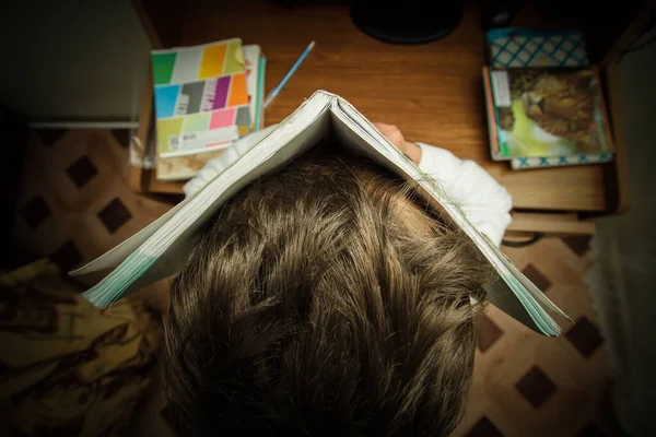 Χαριτωμένο Σχολιαρόπαιδο Κρατώντας Ανοιχτό Βιβλίο Στο Κεφάλι Στο Δωμάτιο — Φωτογραφία Αρχείου