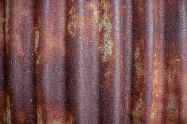 Eski ve paslı grunge kıvrımlı demir, doku arka planı. Eski paslı metal levhanın ayrıntılı görüntüsü.