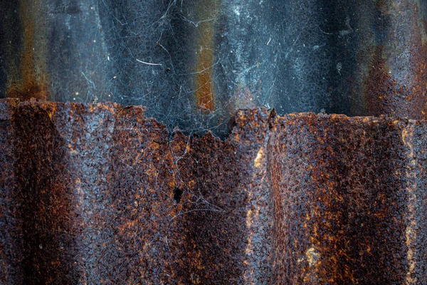 Old and rusty grunge corrugated iron, texture background. Detail view of old rusty corrugated metal sheet.