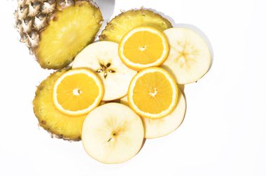 Taze olgun ananas ve elma dilimleri, beyaz arka planda portakal, sağlıklı gıda konsepti, yakın görüş. 