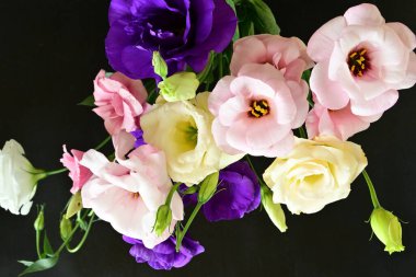 close up eustoma and rose flowers on black background 