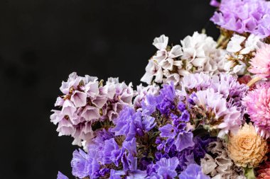 Koyu arkaplanda güzel bir buket çiçek, yakın çekim manzarası.             