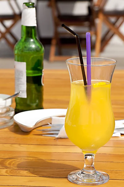 Glass with fresh orange juice on a wooden table — Stock Photo, Image