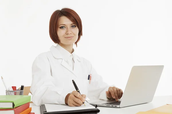 Ärztin sitzt hinter ihrem Schreibtisch — Stockfoto