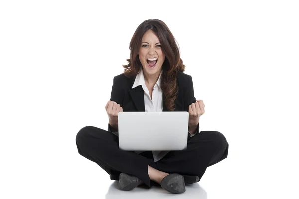 Excited woman with arms up winning online Stock Photo