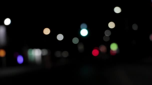 Round multicolored bokeh lights shine from car headlights in a traffic jam on a city street — Stock Video