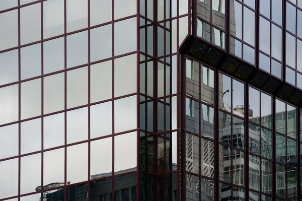 The reflection of buildings in the modern mirror facade of an office building and residential building.