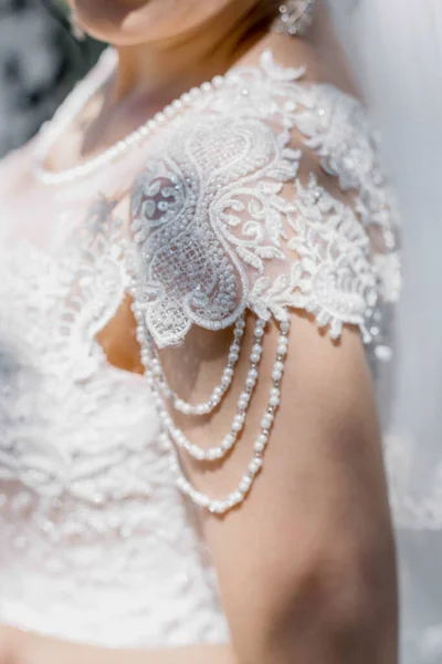 white wedding dress with lace and pearls
