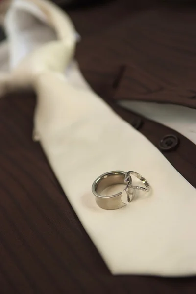 Wedding rings and  grooms tie — Stock Photo, Image