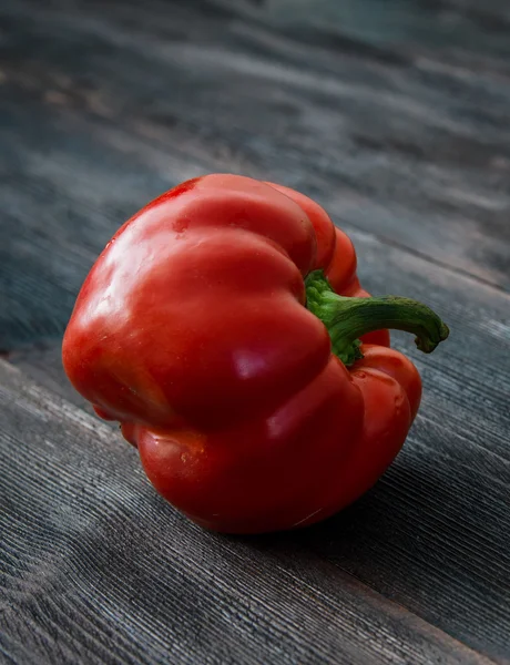 Juicy red pepper on a wooden table — Stock Photo, Image