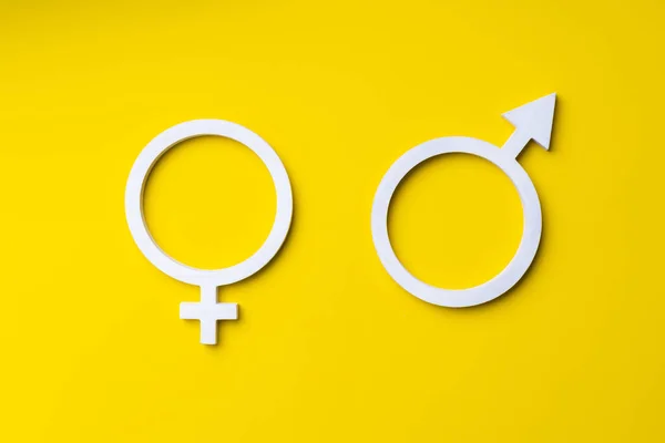 gender symbols of man and woman on yellow background