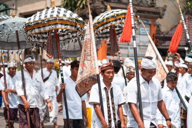 Galungan Tatili. Ellerinde şemsiyeler olan gençlerin geçit töreni. Bali Adası, Endonezya. Kapatın. 26.12.2018.