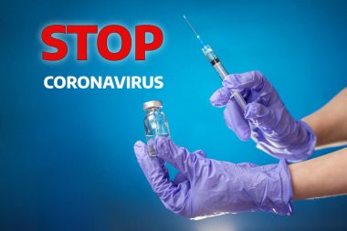 Stop coronavirus. The doctor's hand in medical gloves holds a vial and a syringe for injection. Blue background. The concept of coronavirus, vaccines and health. clipart