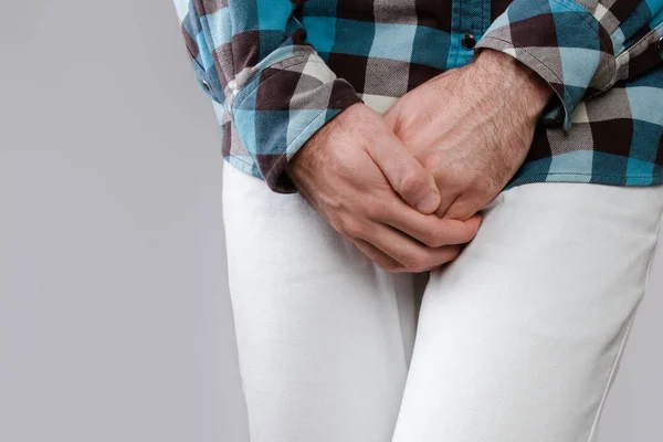 Concept of male sexual diseases. The man holds hands for genitals. Testicular cancer. Close up. — Stock Image Concept Male Sexual Diseases Man Holds Hands Genitals Testicular Cancer Royalty Free Stock Photos