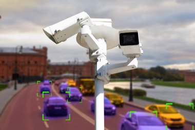 The concept of video surveillance and security technology. CCTV camera on the background of a road bridge with traffic in cloudy weather. Definition zone. clipart