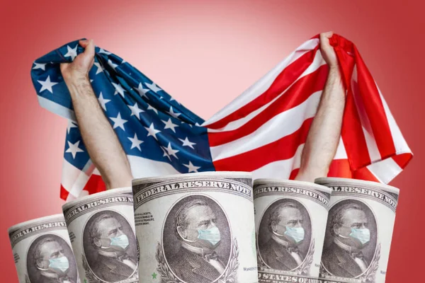 Banknotes with the image of the President in a medical mask on the background of the American flag. Copy space. The concept of the financial crisis, and viral pandemics.