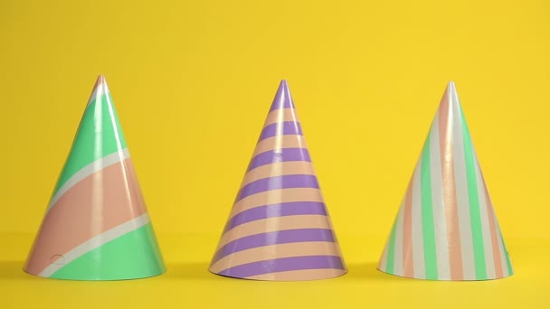 Three Festive Paper Multi Colored Hats Standing Yellow Background Man — Stock Video