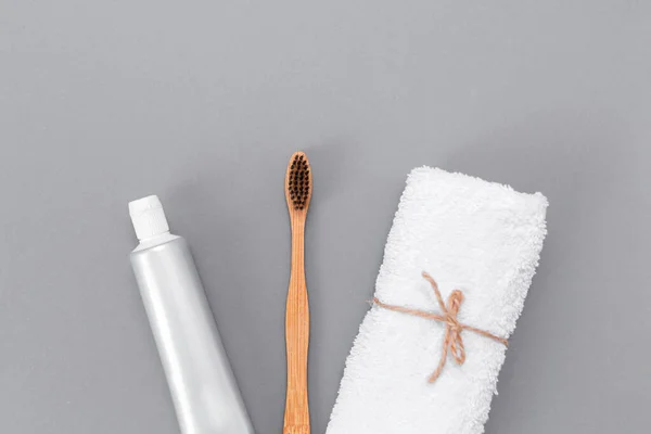 Roll White Towel Toothpaste Bamboo Toothbrush Flat Lay Gray Background — Stock Photo, Image
