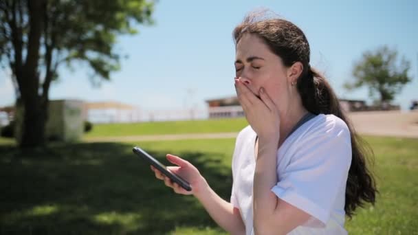 Portrait Young Caucasian Woman Who Uses Phone Yawns Puts Stretch — Video