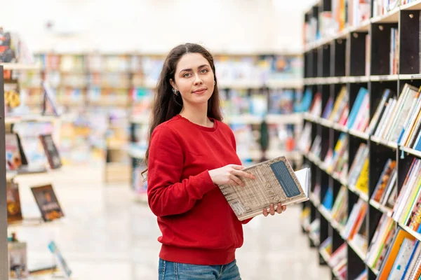 Young Beautiful Smiling Woman Poses Book Her Hands Background Shelves Stock Image