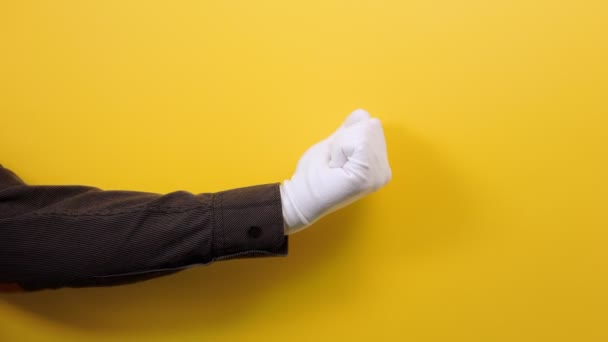 Man Hand Black Shirt White Glove Shows Third Finger Yellow — Stock Video