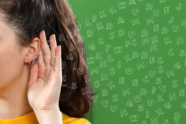 Woman Put Her Hand Her Ear Lot Foreign Letters Green — Stock Photo, Image