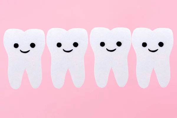 Row White Teeth Cartoon Smiling Faces Carved Out Felt Pink — Stock Photo, Image