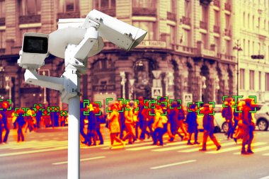 Video surveillance and technology. Video surveillance camera on the background of people walking on a pedestrian crossing. Face recognition effect. Blur. clipart