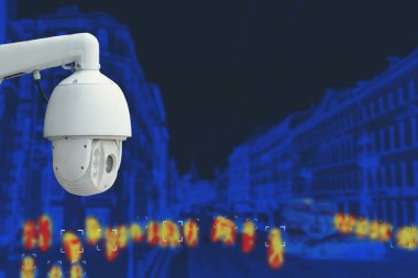The concept of video surveillance and security technology. CCTV camera on the background of the city road with cars and definition people. Night tint. clipart