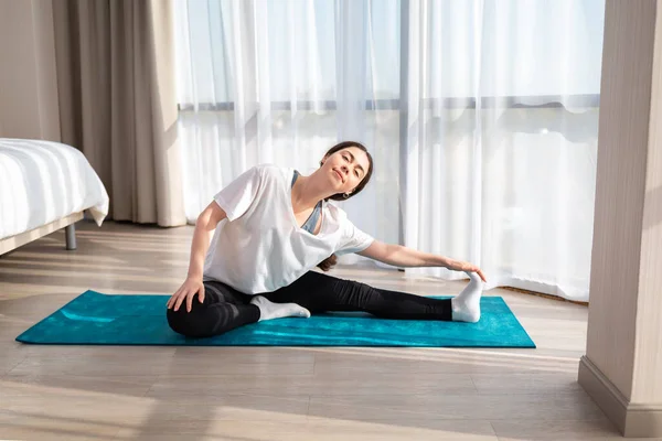 Smiling Woman Sportswear Doing Leg Stretches Indoors Concept Yoga Home — Stock Fotó