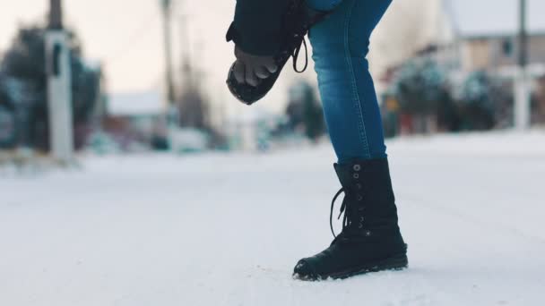 Woman Stands Snow Covered Road Puts Rubber Treads Her Shoes — Stok video