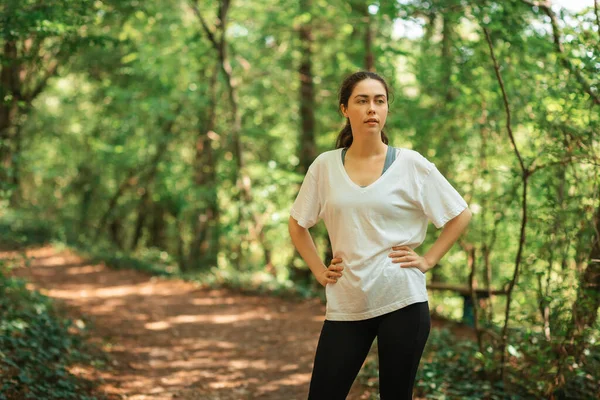 Portrait of woman relax after training at summer forest. The concept of cross-country running.