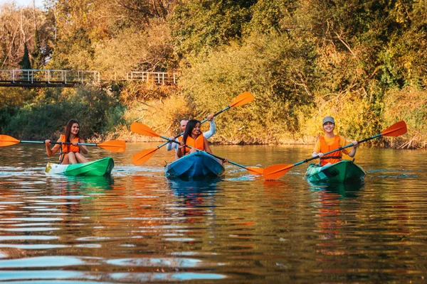 A group of friends are kayaking. Active recreation of young people in nature. Outdoor activity. Copy space.
