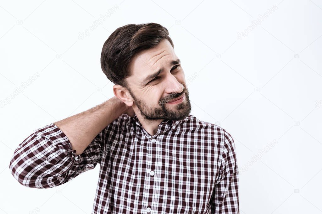 Bearded man stands with neck pain and suffers. 