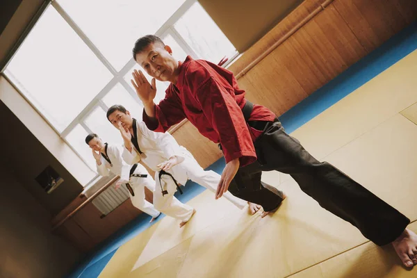 A man in a red kimono and a black belt. — Stock Photo, Image