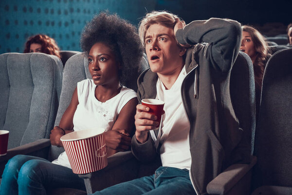  A man is surprised while watching a movie. 