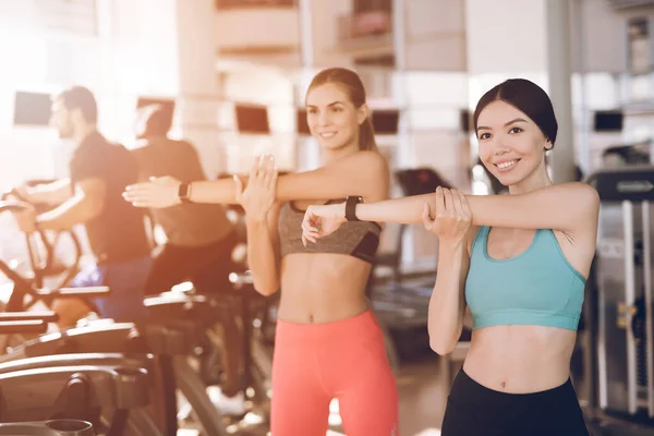 Two happy girls knead in the modern gym. — Stock Photo, Image